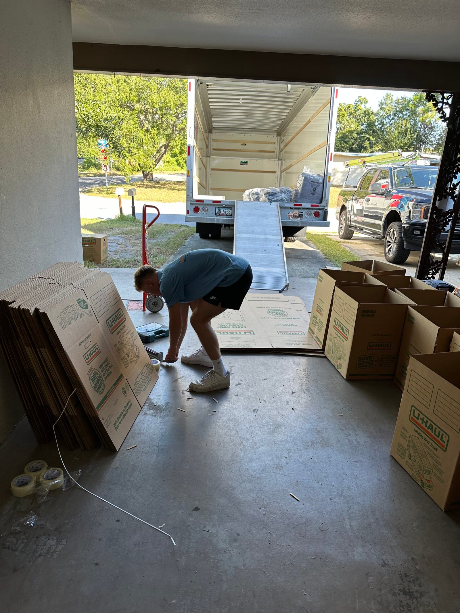 Merit and Muscle Movers Tampa movers unloading furniture from truck