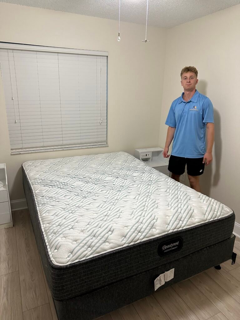 Merit and Muscle Moving Tampa Bay movers preparing mattress for transport