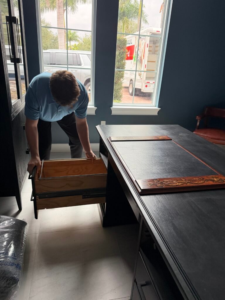 Merit and Muscle Moving Tampa Bay mover carrying item in uniform