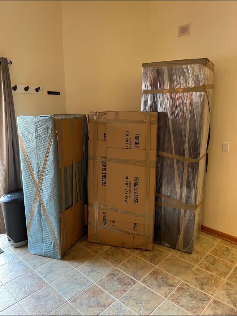 Merit and Muscle Moving Tampa Bay movers wrapped items ready for loading