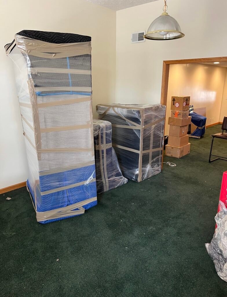 Tampa Bay movers Merit and Muscle Moving wrapping living room furniture