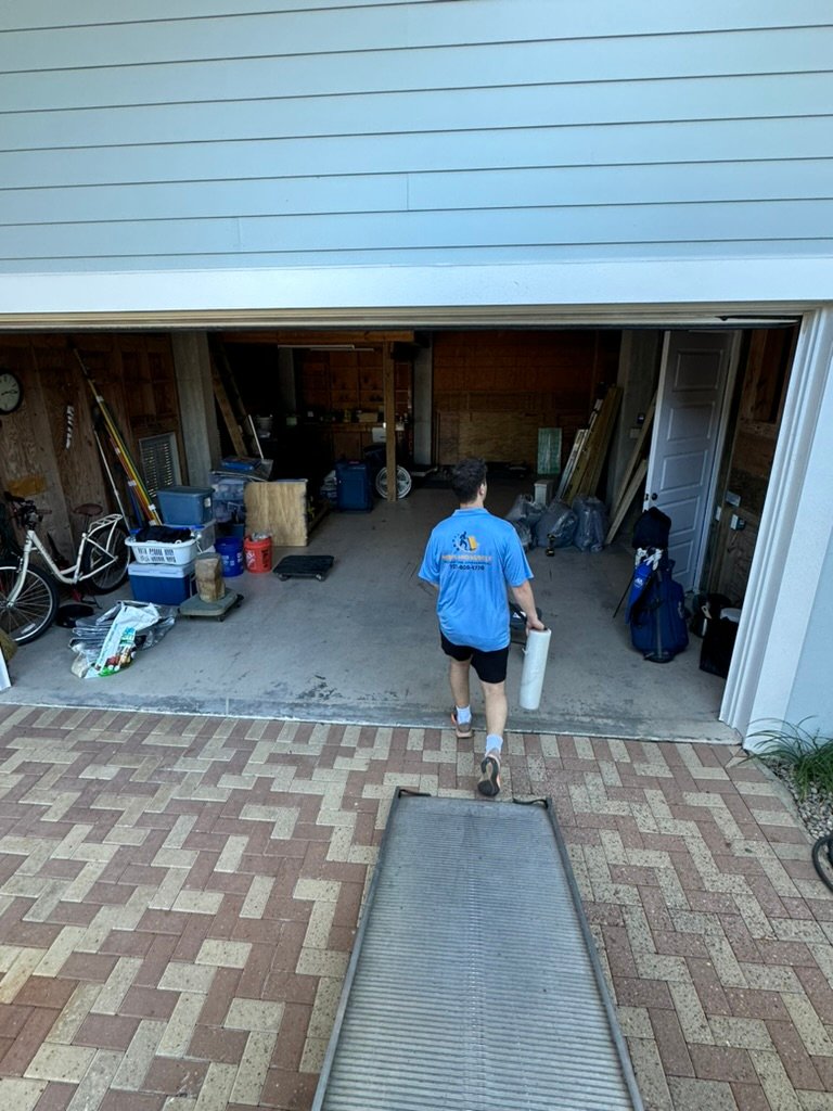Movers in Wiregrass Ranch Wesley Chapel FL 1 Merit and Muscle mover in a Wiregrass Ranch garage with packed boxes