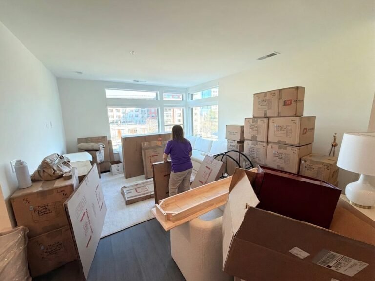 Mover unpacking boxes in a downtown apartment in Tampa, FL