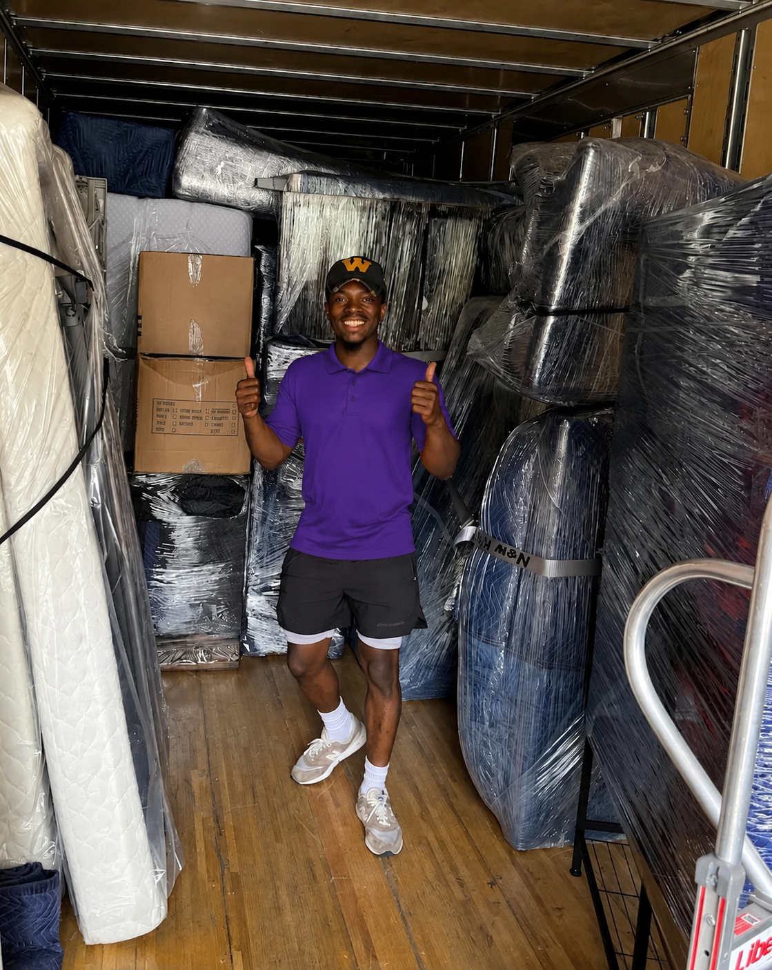 Mover giving two thumbs up inside a fully packed moving truck in Wesley Chapel, FL